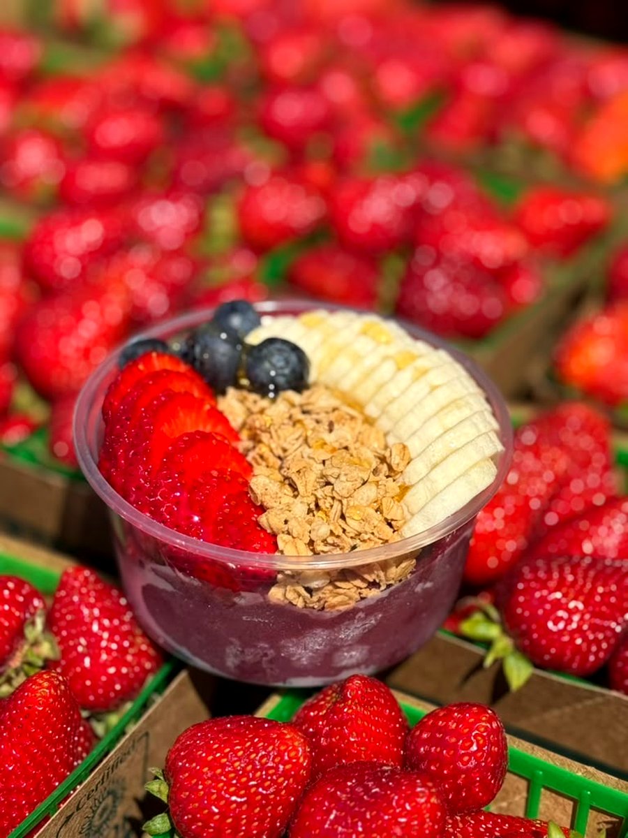 Açaí bowl topped with strawberries, blueberries and granola
